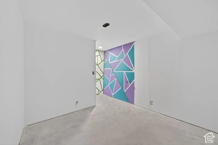 Interior space featuring a concrete floor and white walls