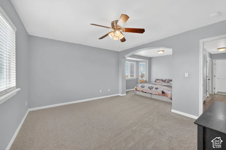Spacious room featuring neutral carpeting and light-colored walls