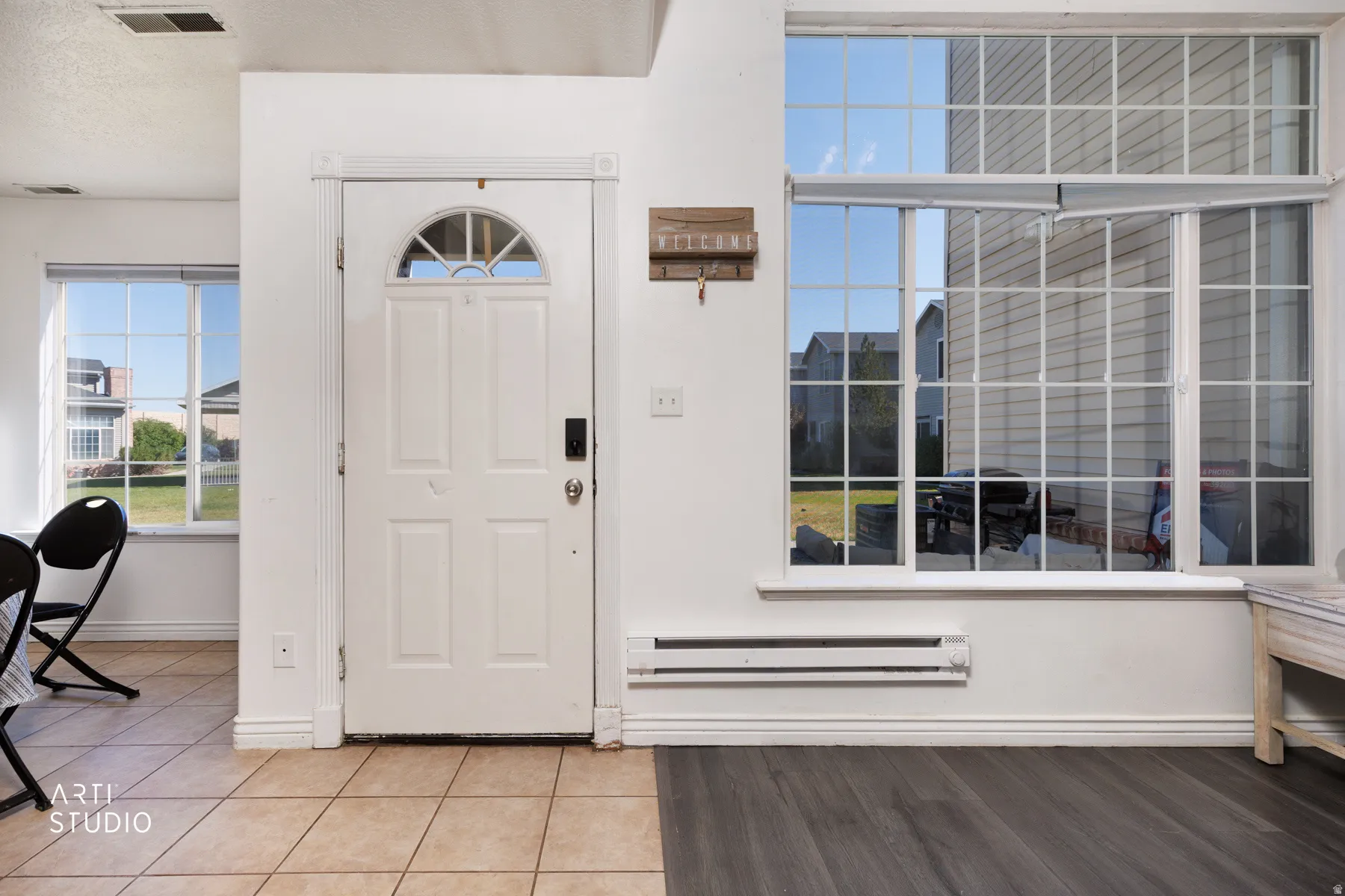 Entryway featuring a paneled door with a transom window