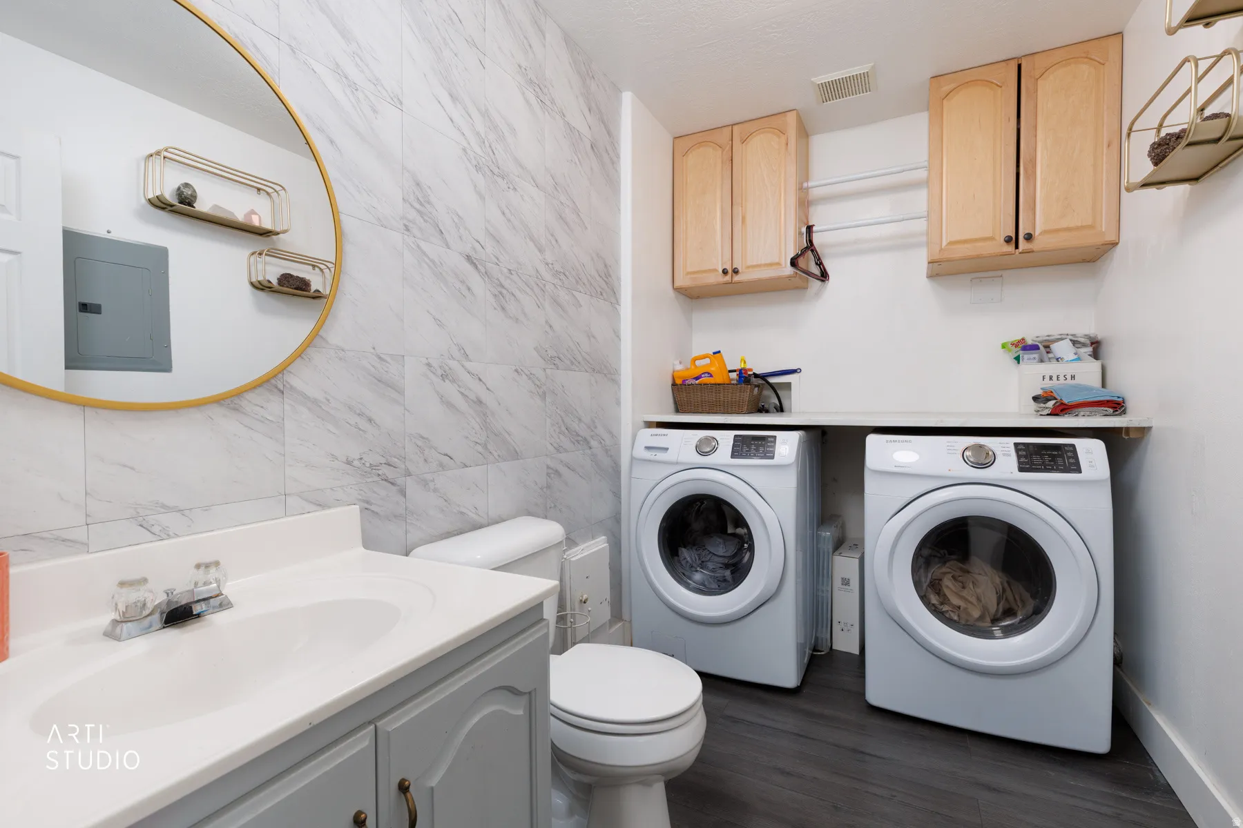 Full-size laundry appliances with built-in cabinetry and countertop space