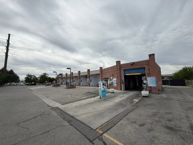 Commercial property featuring a brick facade structure with multiple service bays