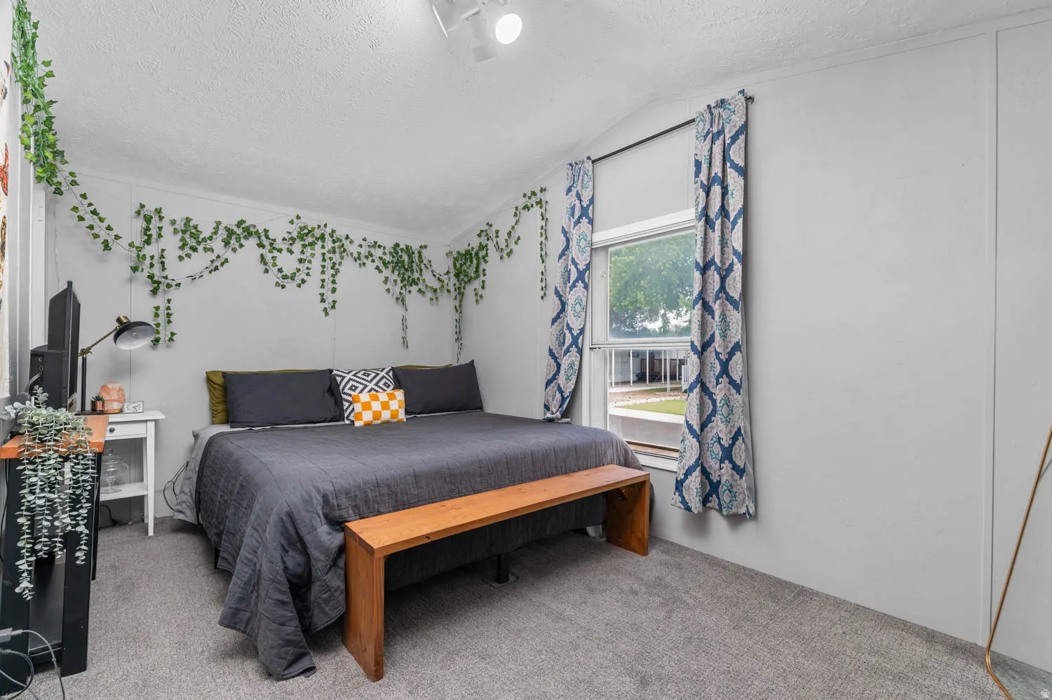 Bedroom featuring neutral wall colors, textured ceiling, and gray carpeting
