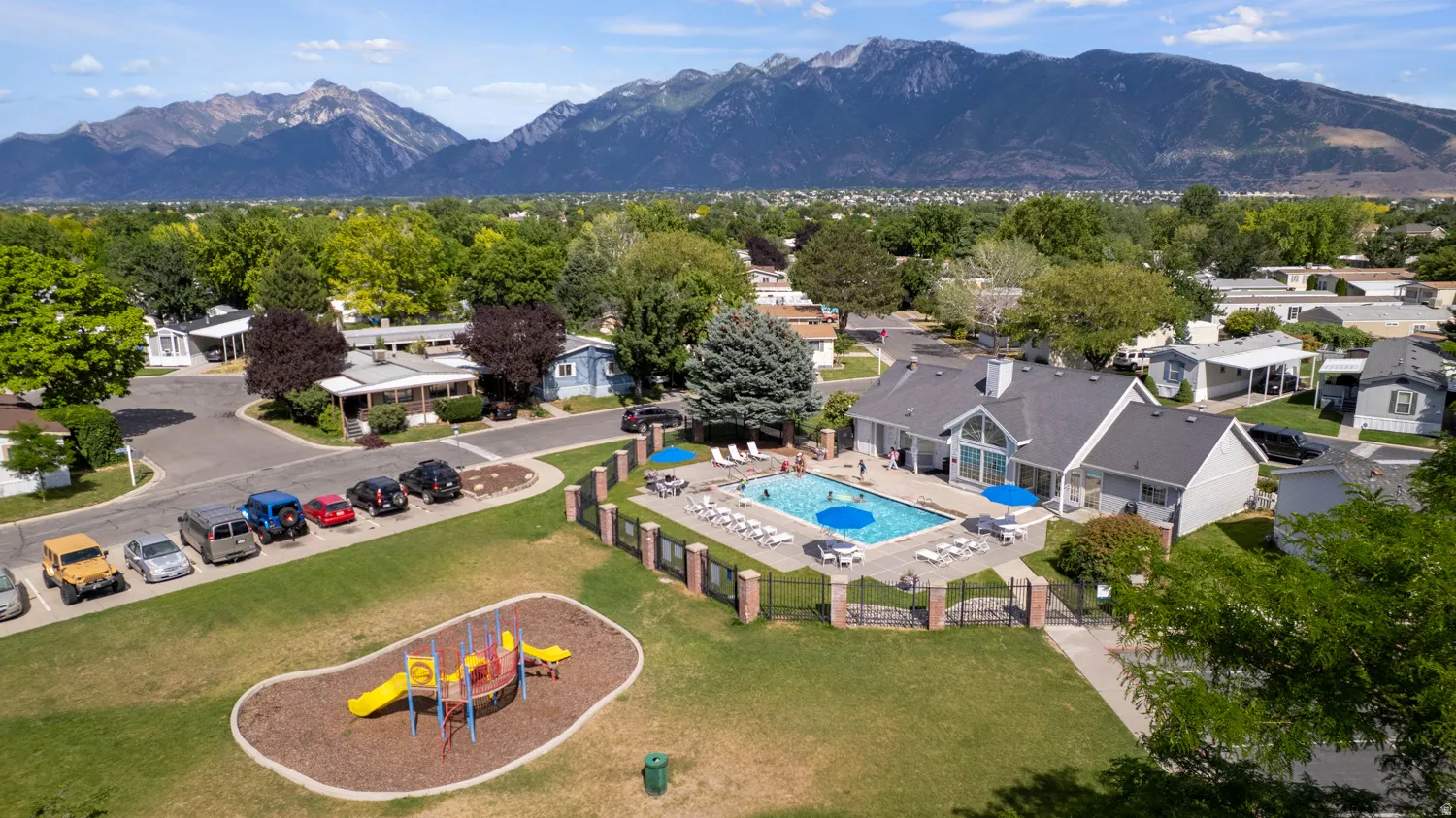 Community amenities include a swimming pool, children's play area, and an expansive green space