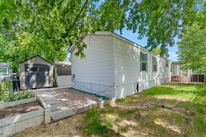 White siding exterior with green window shutters