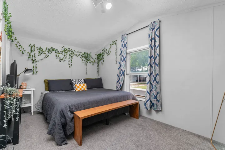 Bedroom featuring neutral wall colors, textured ceiling, and gray carpeting