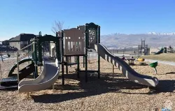 Community playground featuring multiple slides and climbing structures