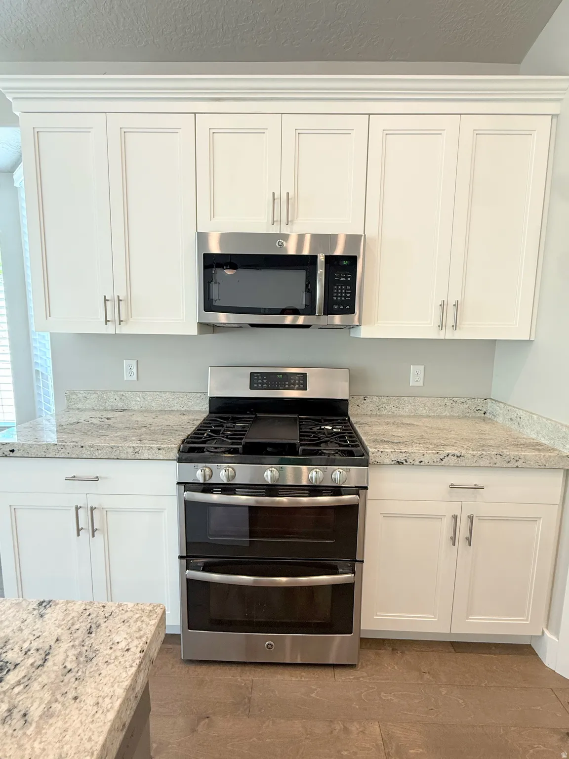 Stainless steel gas range with a double oven