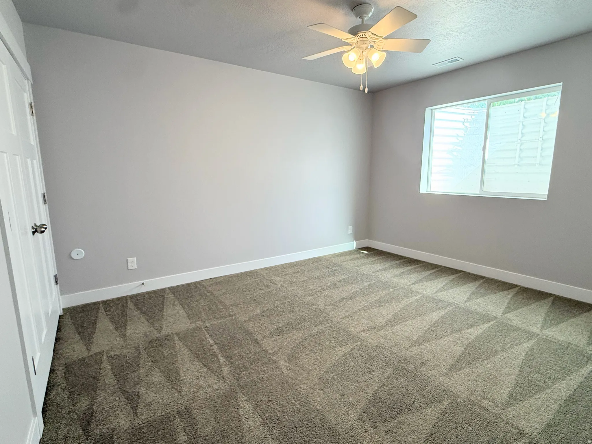 Bedroom # 6 featuring carpet flooring, neutral painted walls, a window with horizontal blinds, a white ceiling fan with integrated lighting, and white baseboards