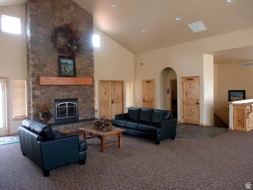 Spacious common area featuring a floor-to-ceiling stone fireplace, sitting area and serving space. This can be rented out.