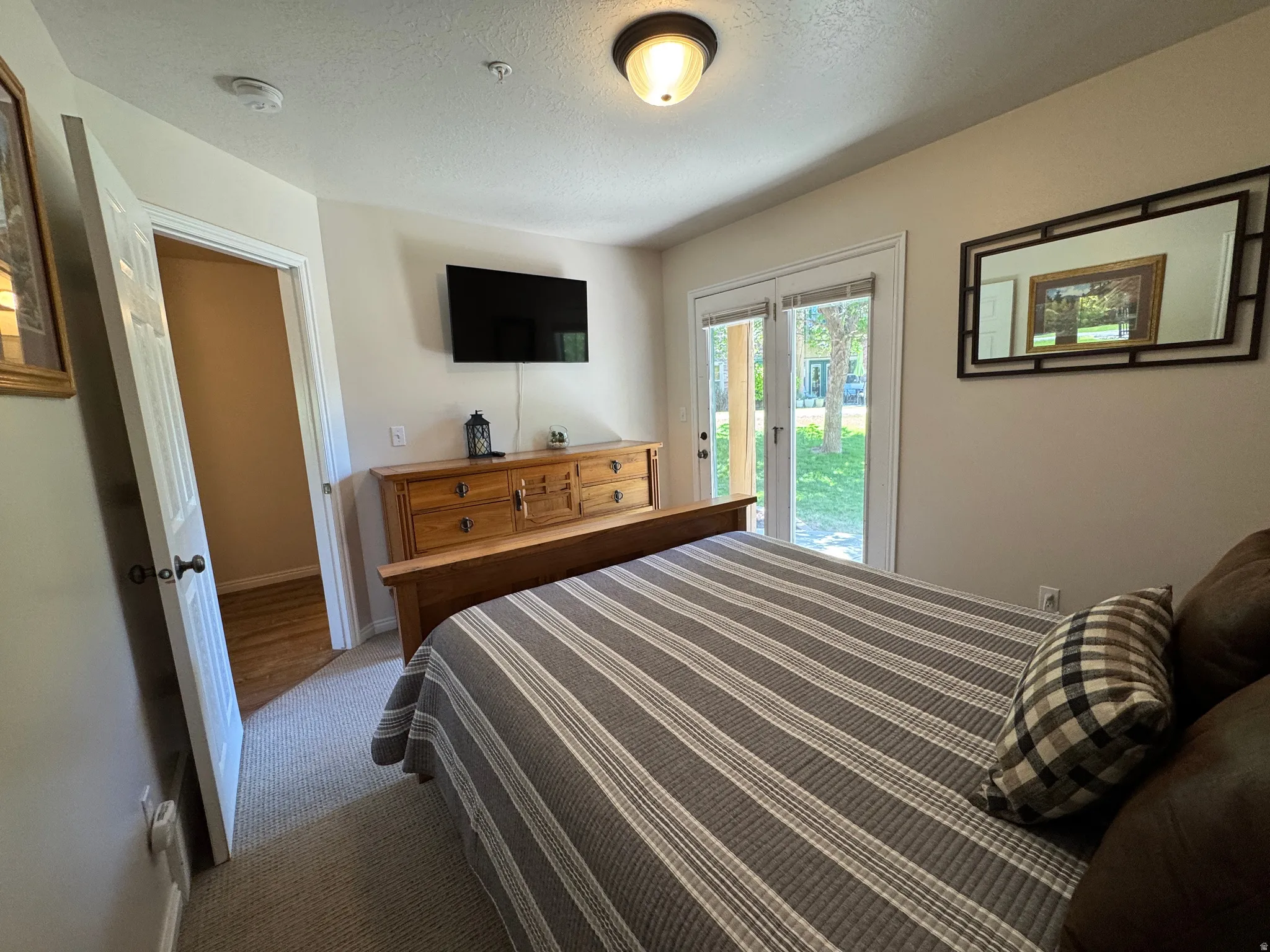 Main floor bedroom with access to patio and hot tub