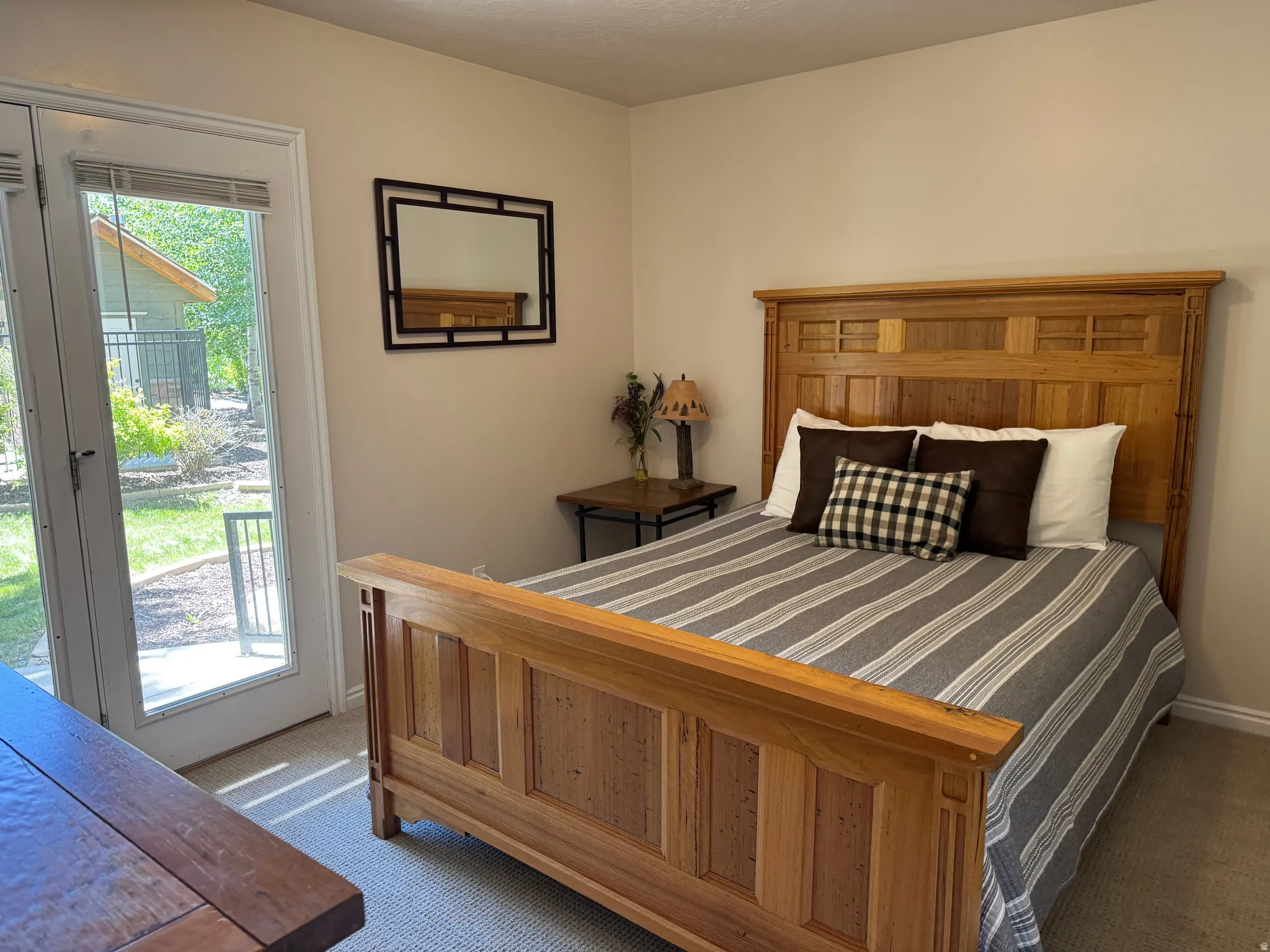 Main floor bedroom with access to patio and hot tub