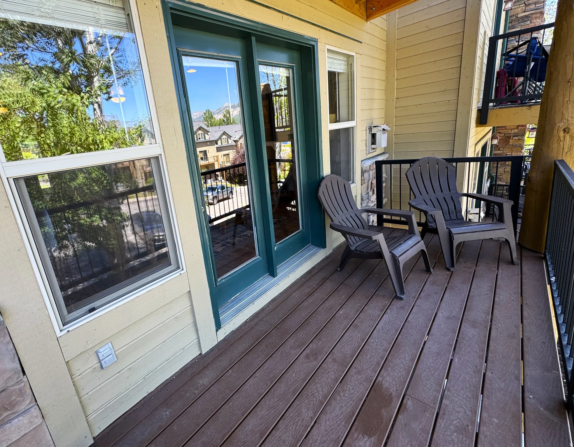 Outdoor deck featuring composite flooring and newly installed iron railings.