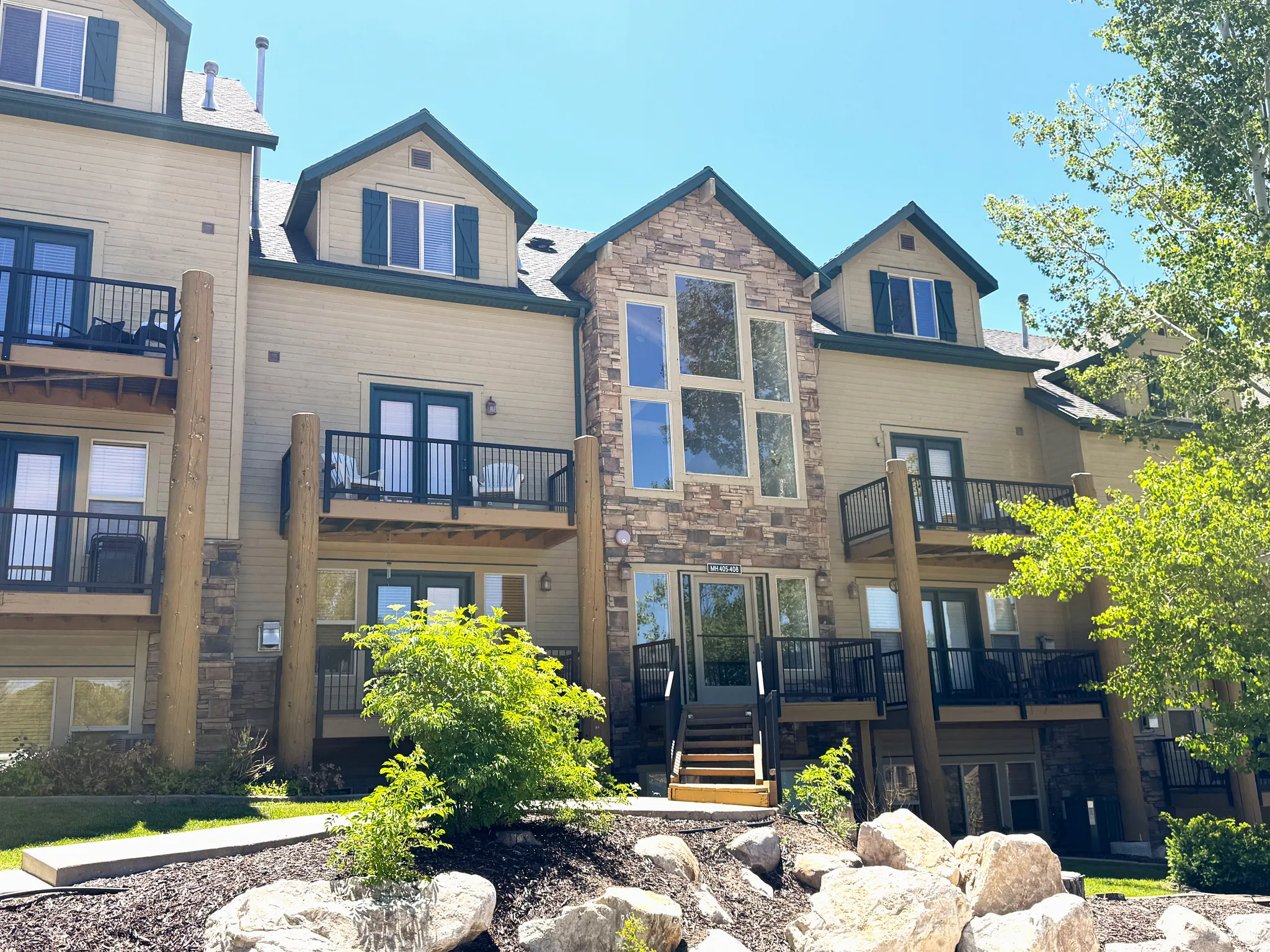 Multi-level building with stone and siding exterior. Brand new railings installed.