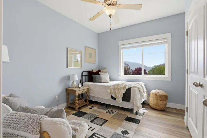 Room featuring light blue walls and wood-finish flooring