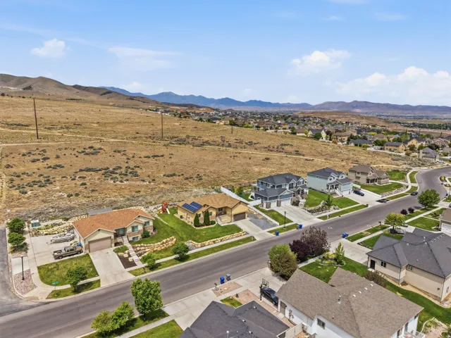 Residential street with single-family homes featuring varied architectural styles and front landscaping