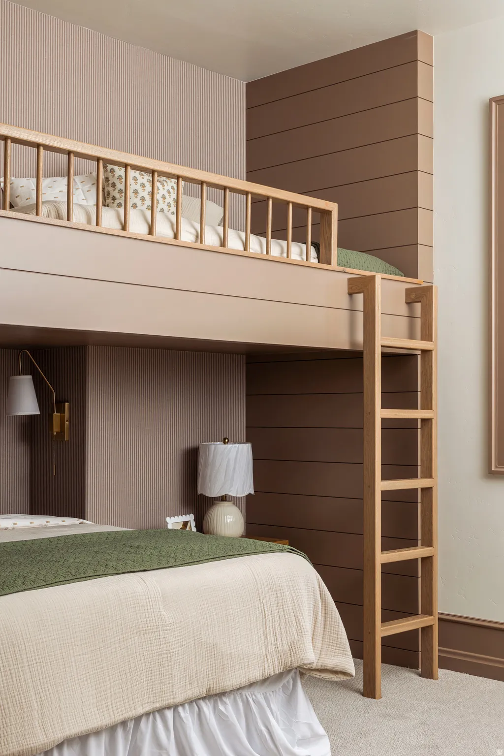 Integrated bunk bed system featuring natural wood-finish ladder and railing
