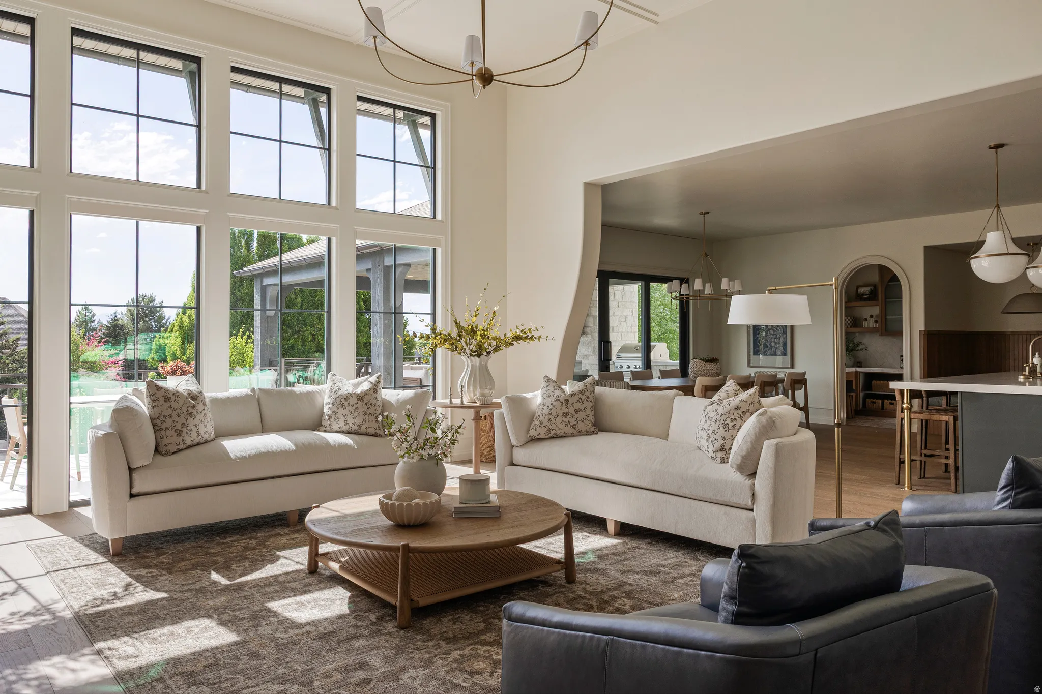 Spacious living area featuring large pane windows and wood-finish flooring