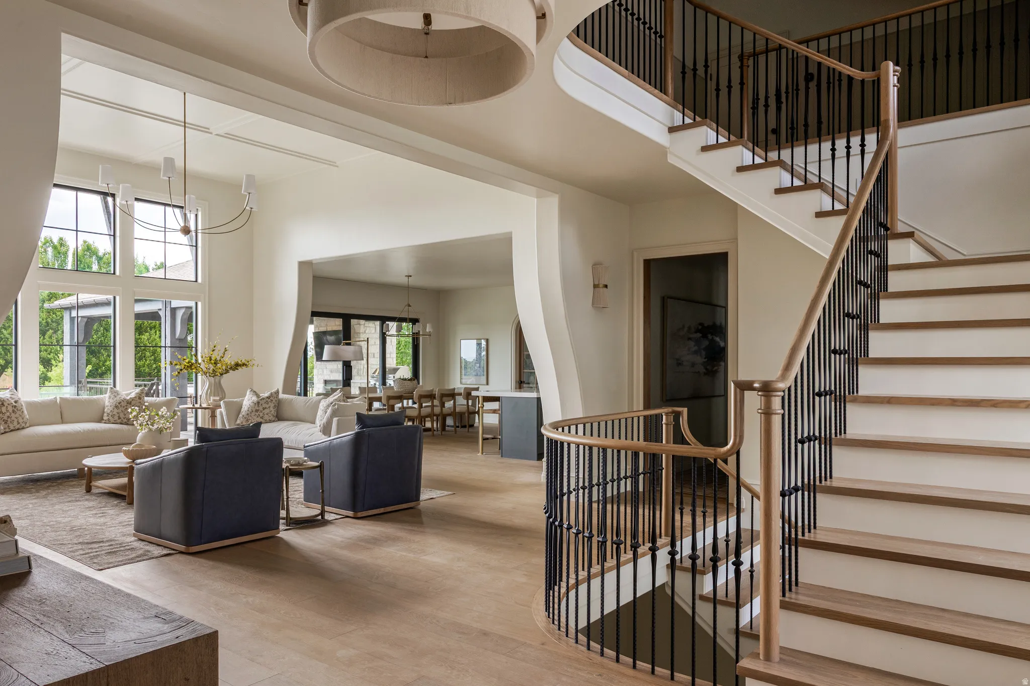 Curved staircase with wood-finish treads and wrought iron balusters