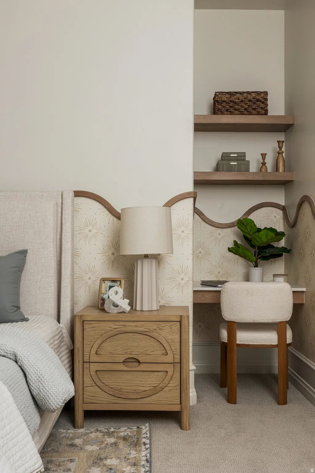 Built-in desk area featuring floating shelves and upholstered chair