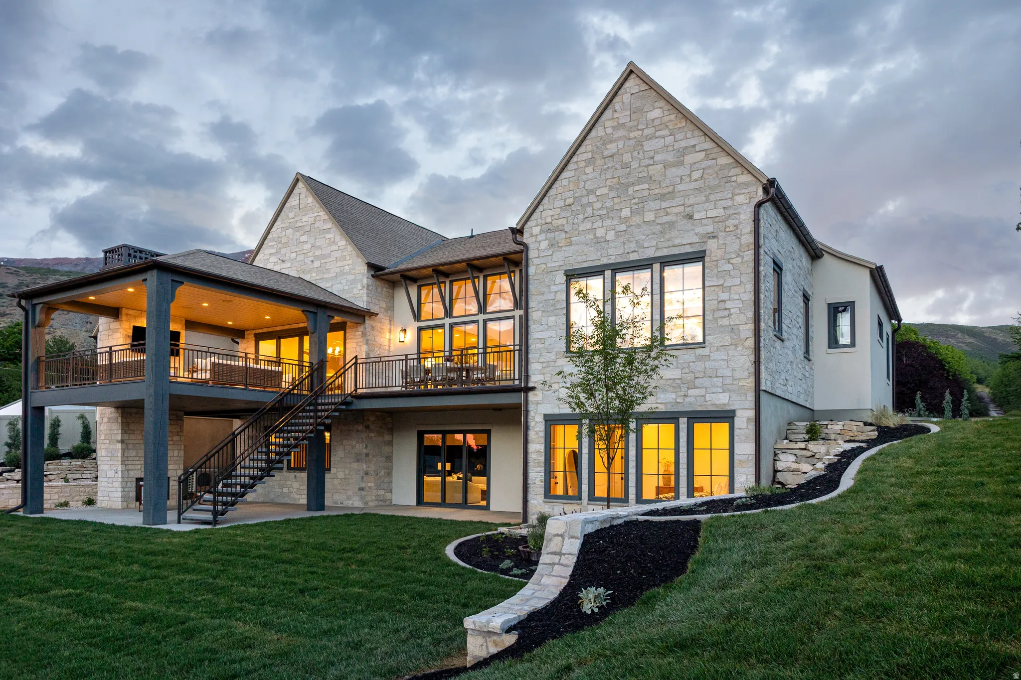 Stone and stucco exterior featuring multiple levels of outdoor living space