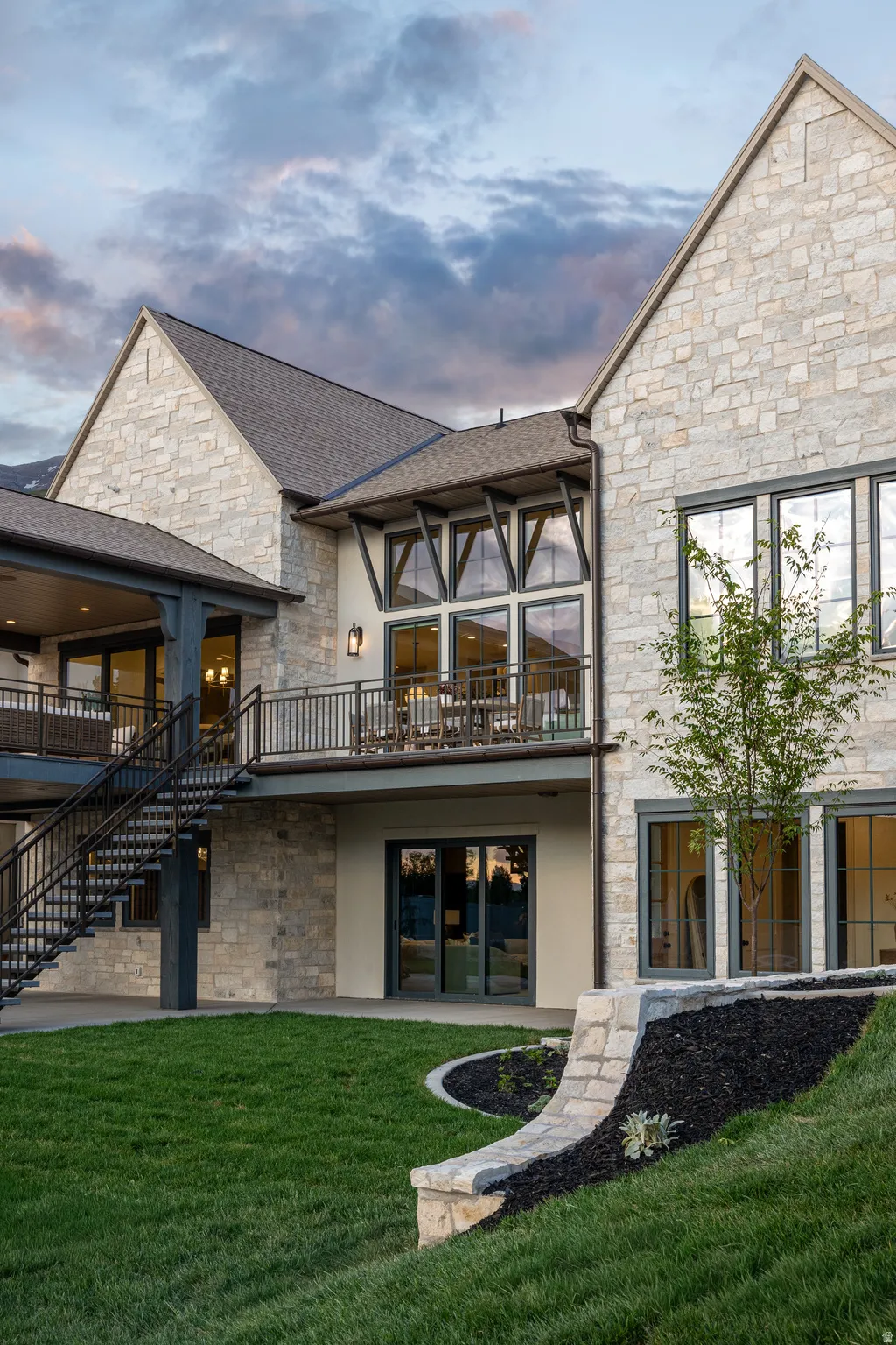 Stone veneer exterior featuring multiple gables and a multi-level design