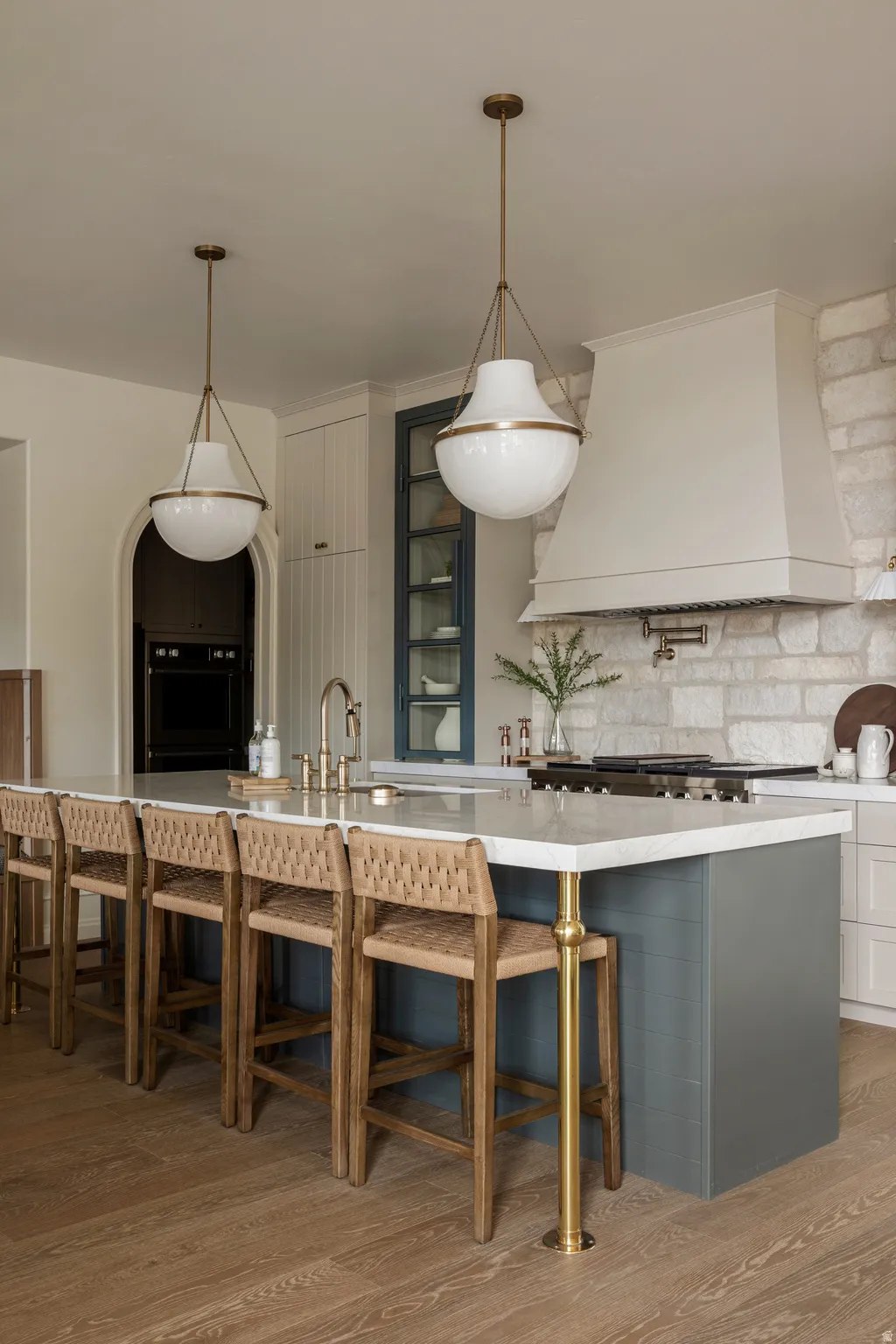 Kitchen featuring a large island with a light-colored countertop and a matte teal base