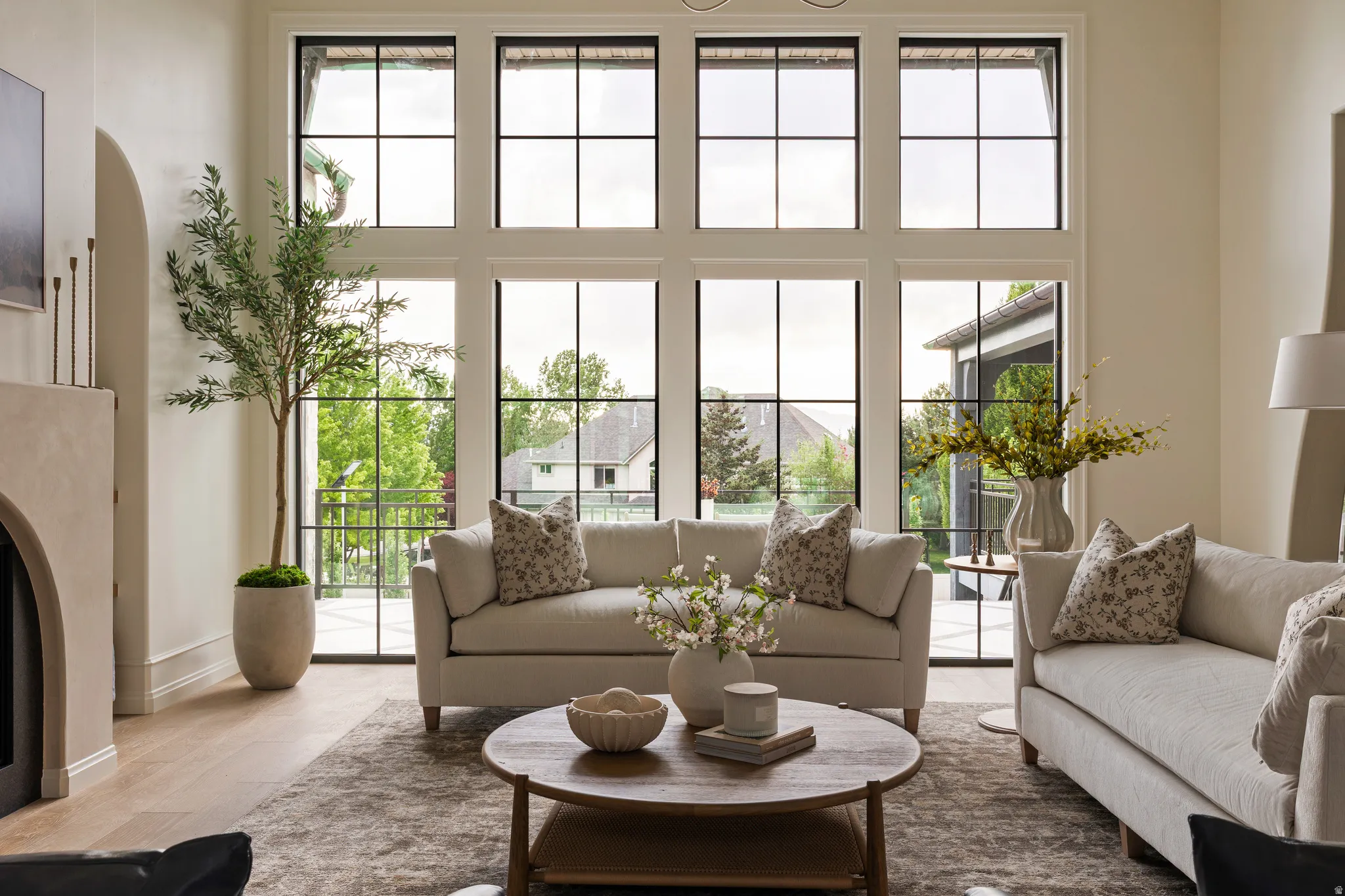 Two-story window wall featuring black grid framing