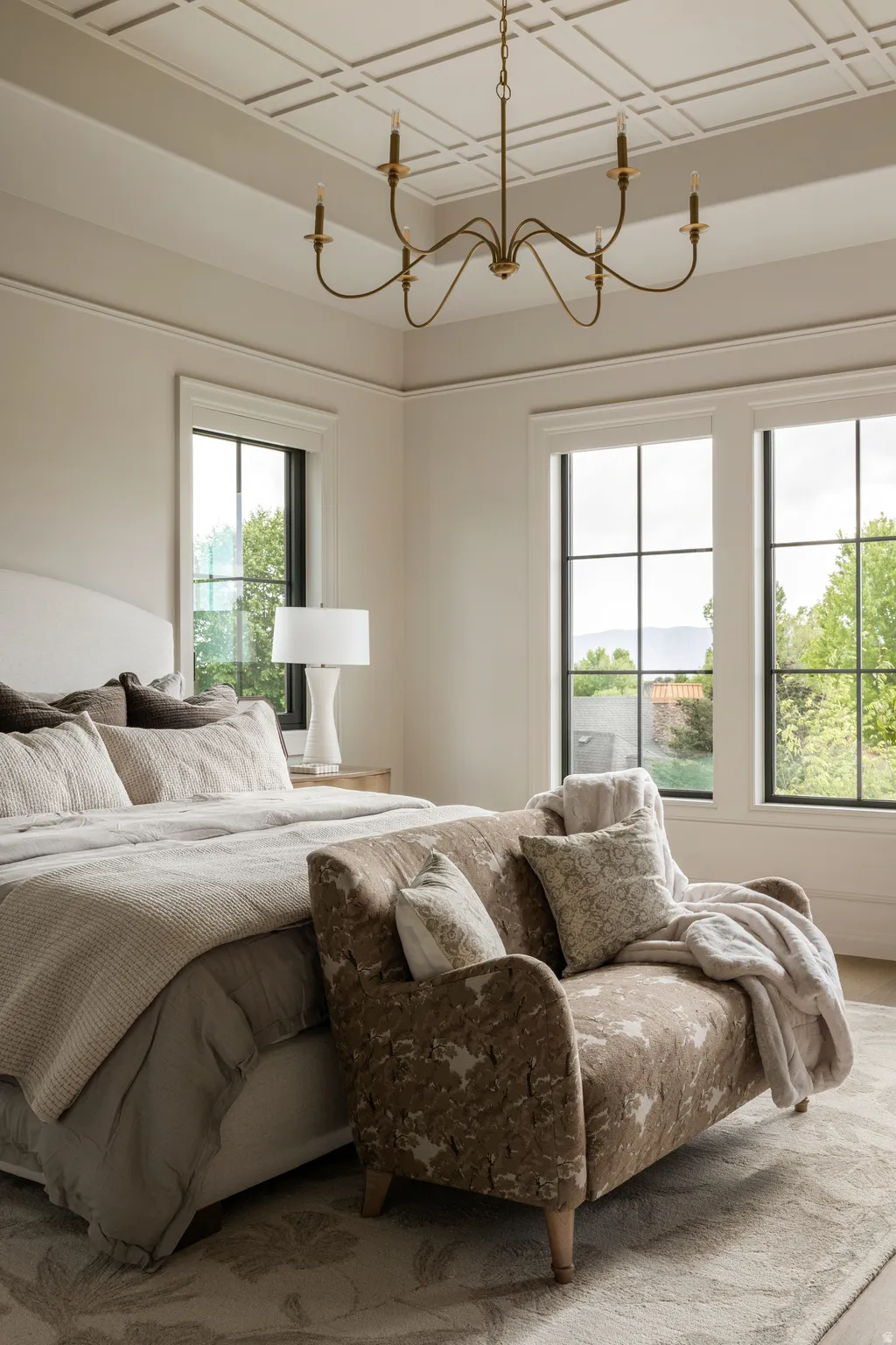 Coffered ceiling with a bronze chandelier, offering an elegant aesthetic