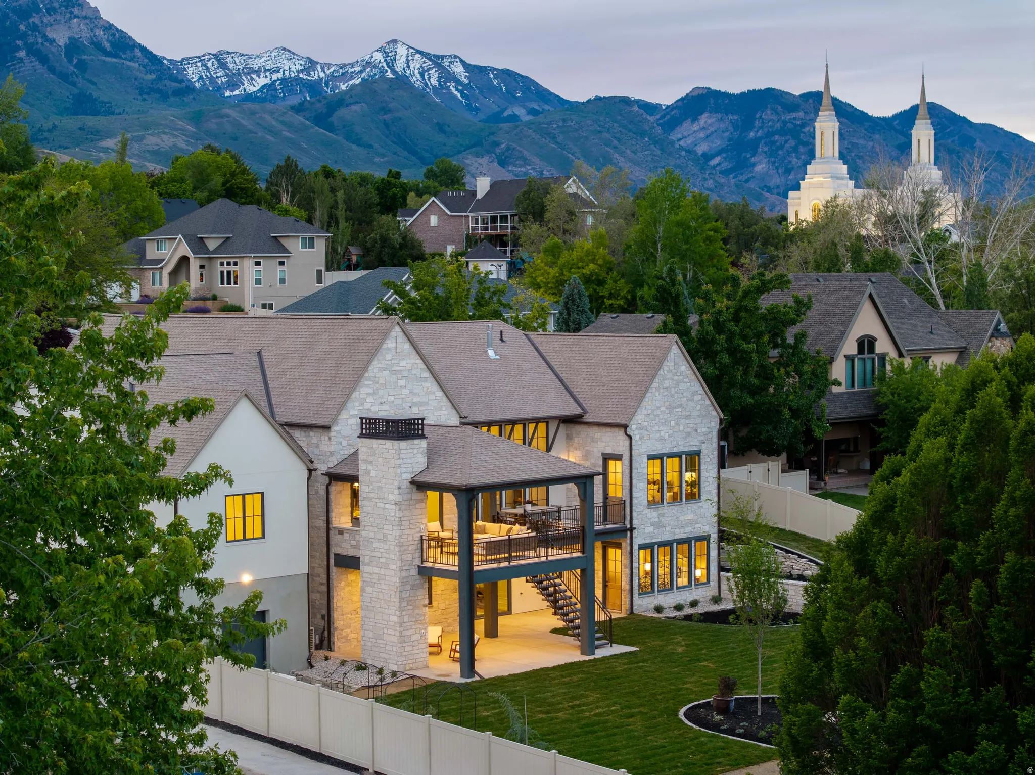 Stone and stucco exterior with dark trim windows