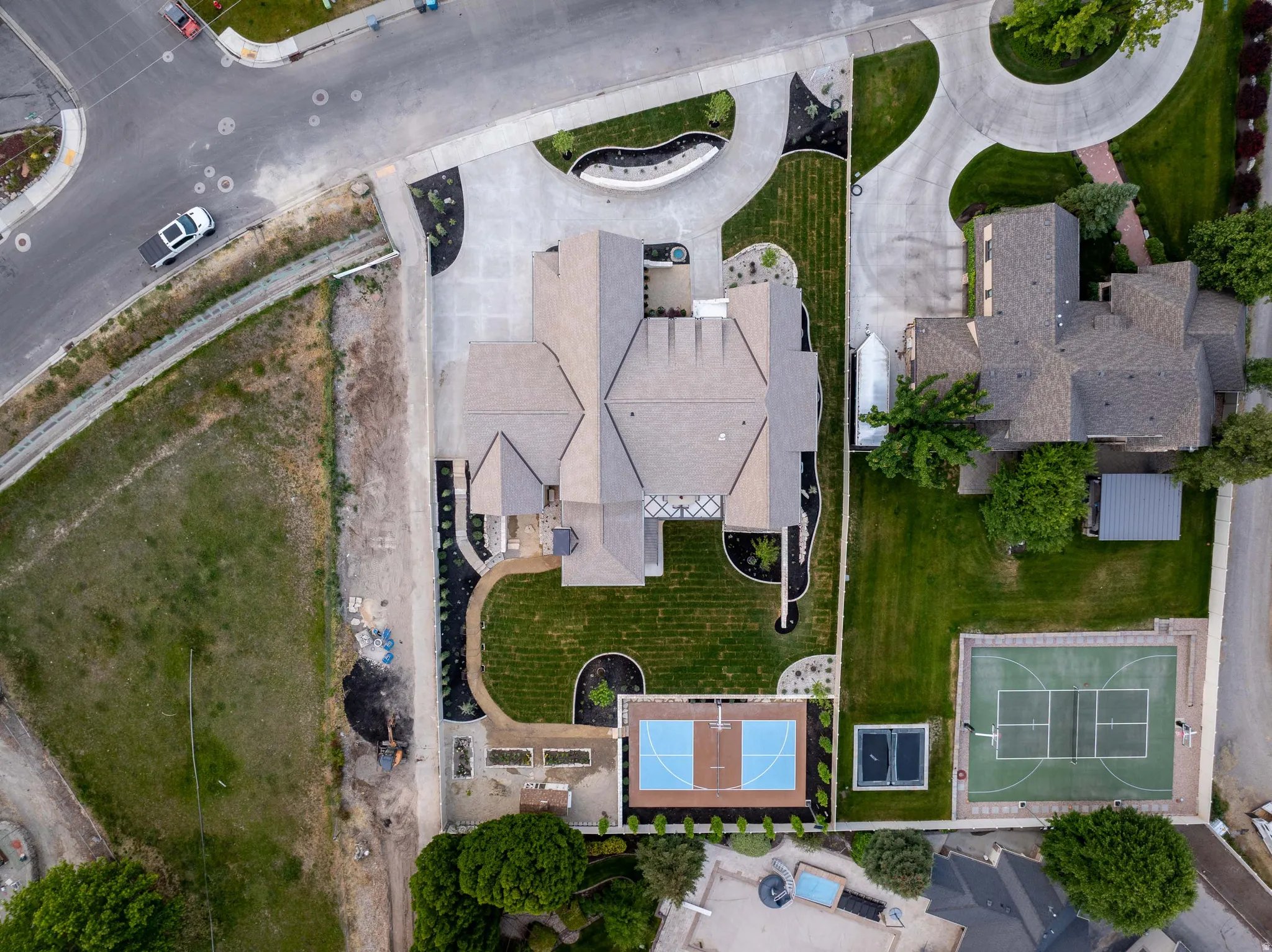 Expansive property featuring a multi-level roofline and a large circular driveway