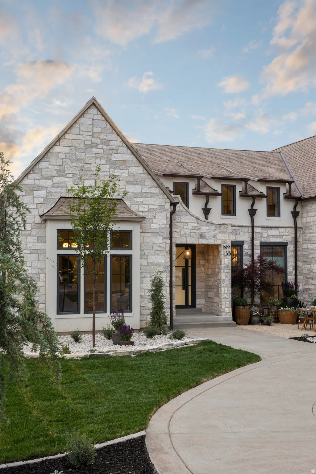 Stone-clad exterior featuring a prominent gable roofline and dark-framed windows