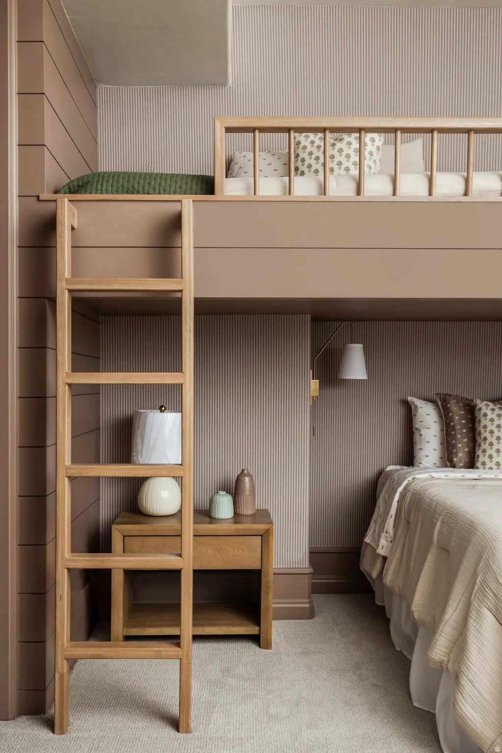 Integrated sleeping arrangements featuring a built-in loft bed with a wooden safety rail and a coordinating wooden ladder