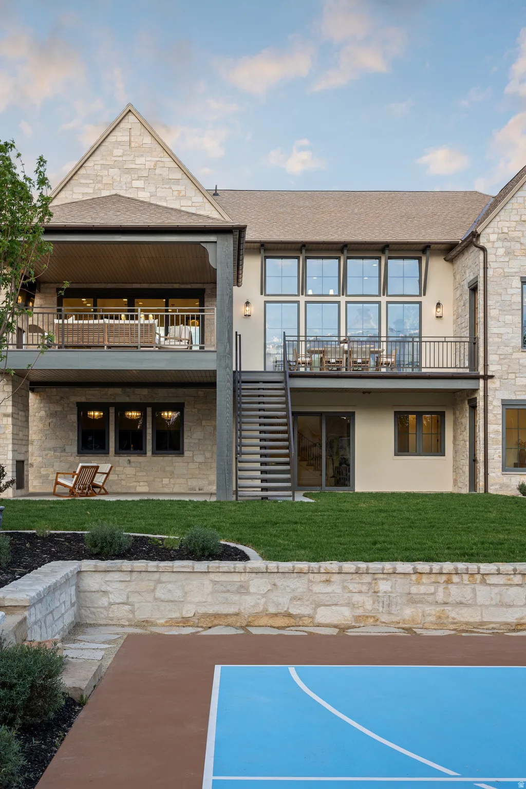 Expansive stone and stucco exterior with multiple covered balconies