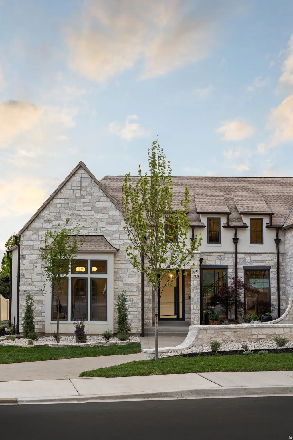 Stone-clad exterior featuring a prominent gabled roofline