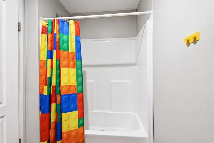 White fiberglass shower and tub combination