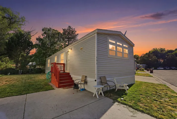 Property exterior with light-colored siding and a red-painted entry deck