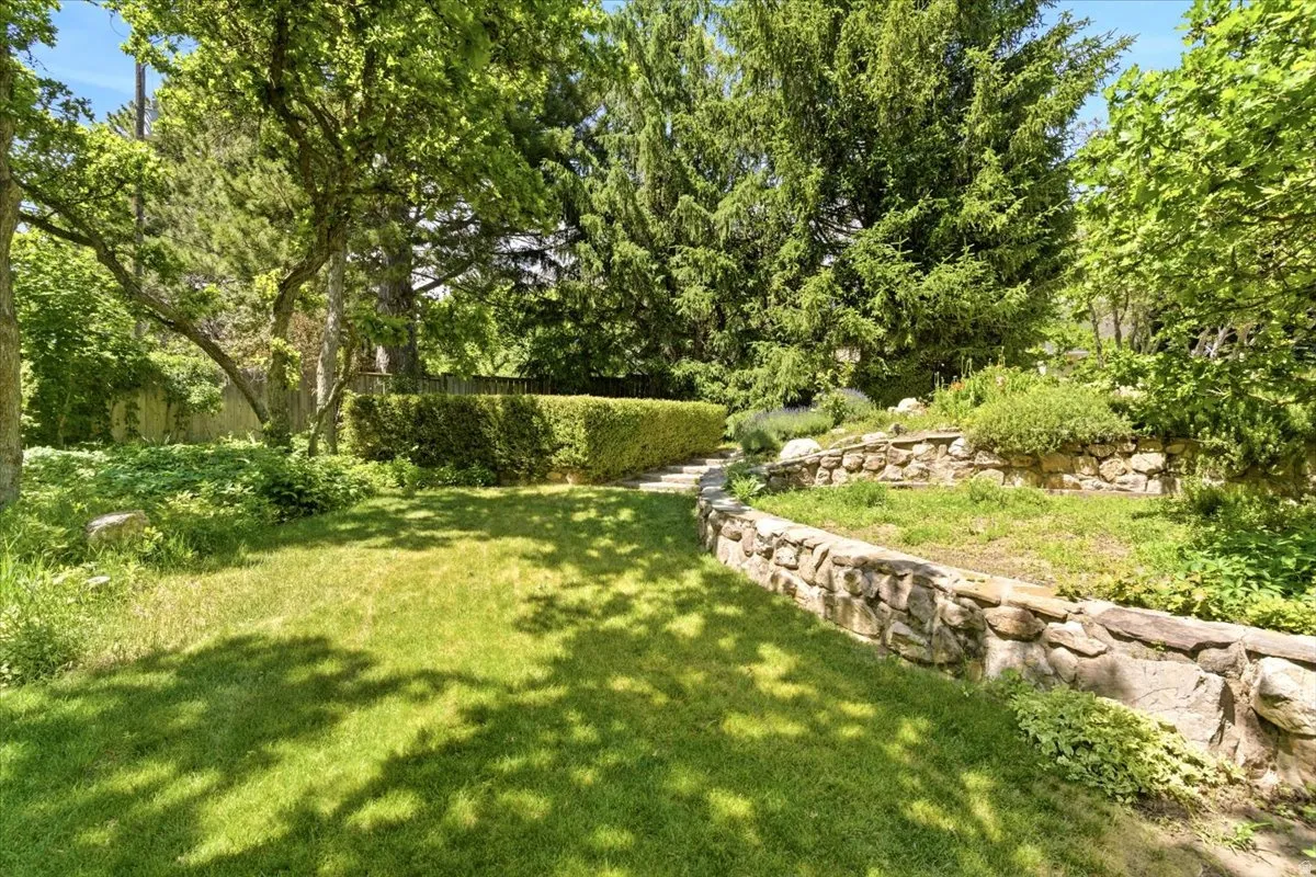 Private, part fenced backyard with mature trees