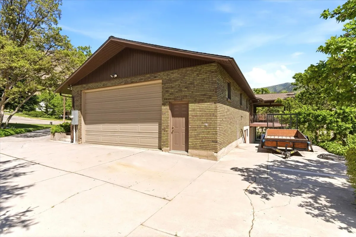 Abundant parking space with oversized extra-wide 2 car garage, 10 ft garage door, dedicated workshop space, utility sink, and large RV pad