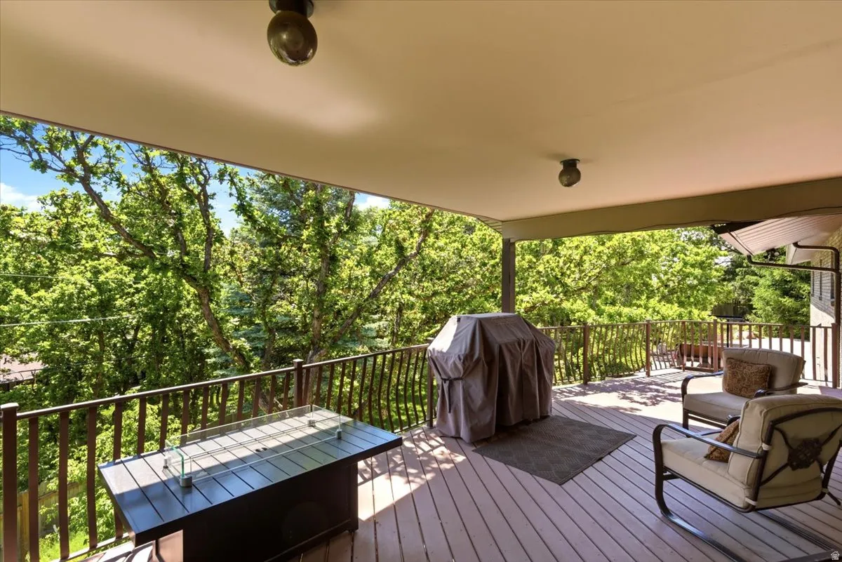 Family room leads out to covered TimberTech deck with wrought iron railings
