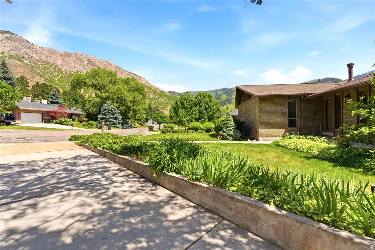 Abundant parking space with oversized extra-wide 2 car garage, 10 ft garage door, dedicated workshop space, utility sink, and large RV pad