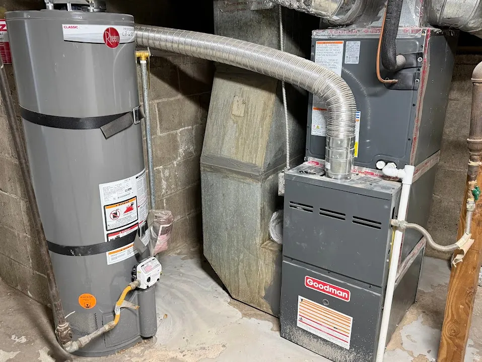 Rheem water heater and Goodman HVAC system with visible ductwork