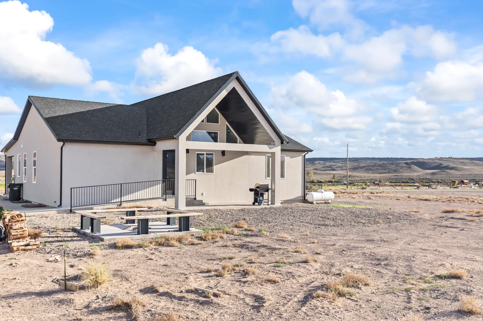 Modern ranch-style residence featuring a prominent gable roofline and light-colored siding