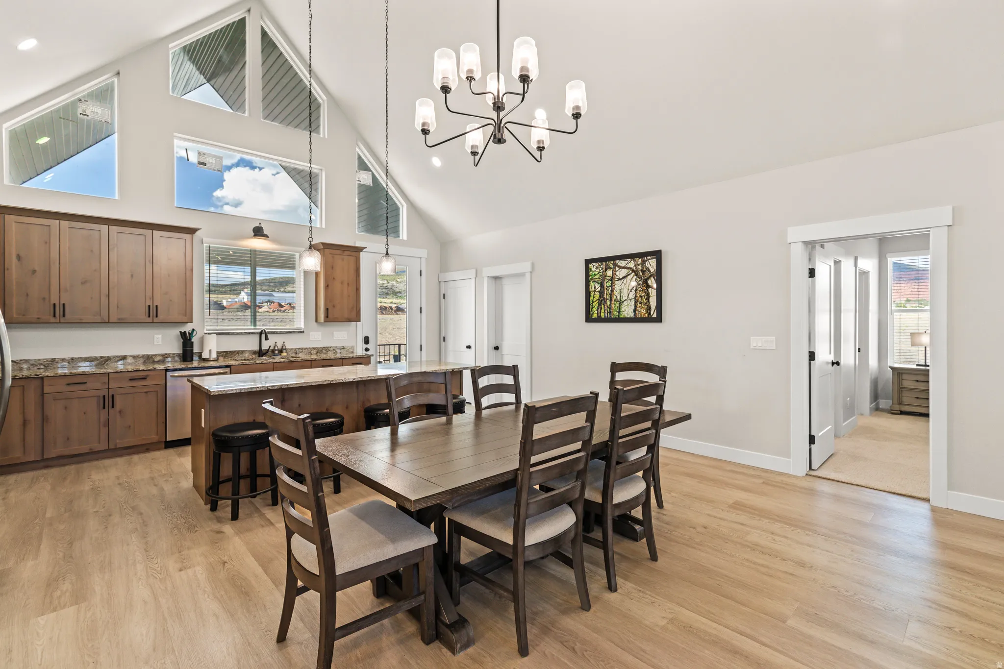 Open-concept living space featuring a vaulted ceiling and ample natural light