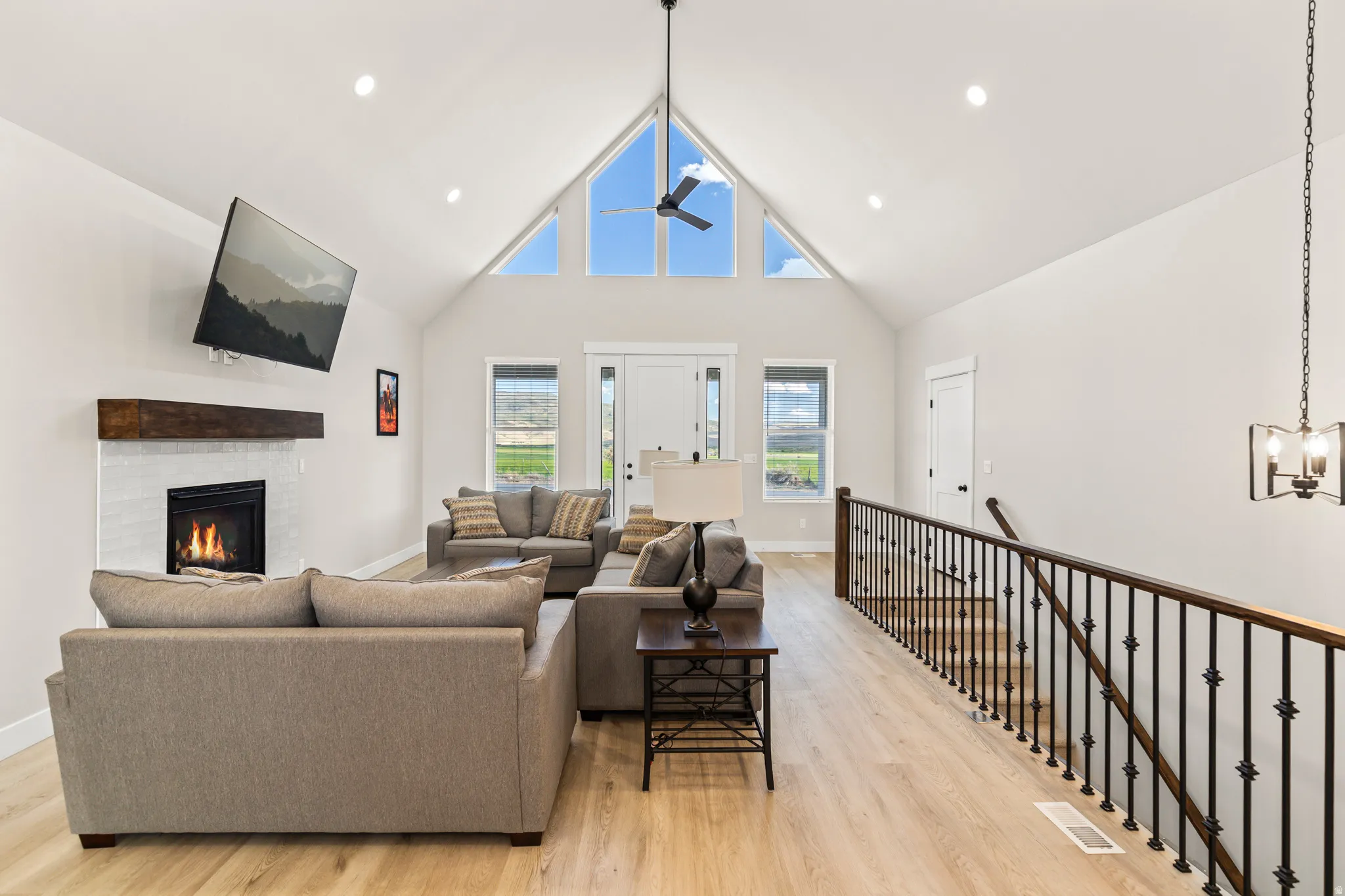 Vaulted ceiling great room with wood-finish flooring