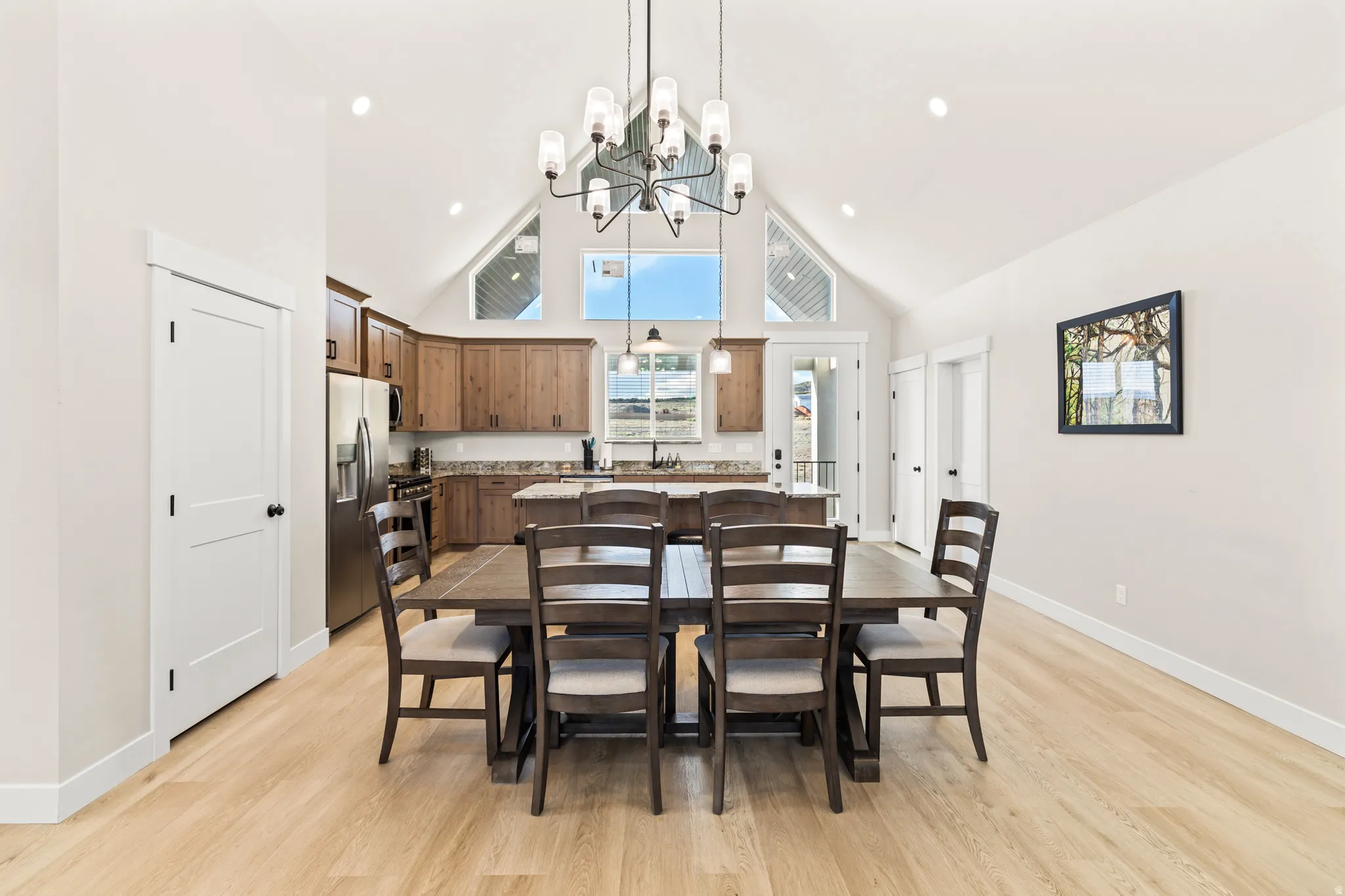 Open-concept living space with vaulted ceilings and wood-finish flooring