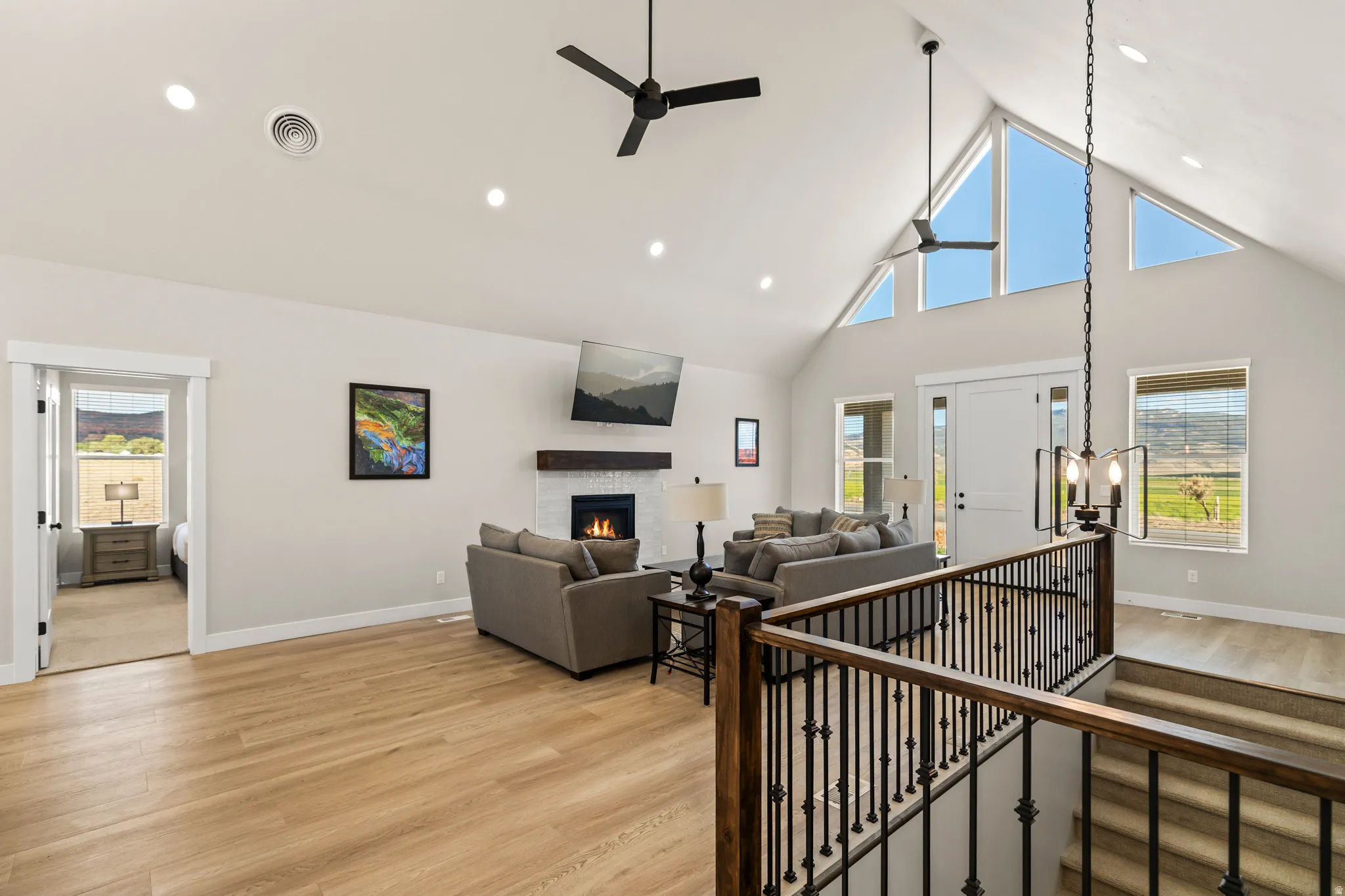 Vaulted ceilings with triangular upper windows and recessed lighting