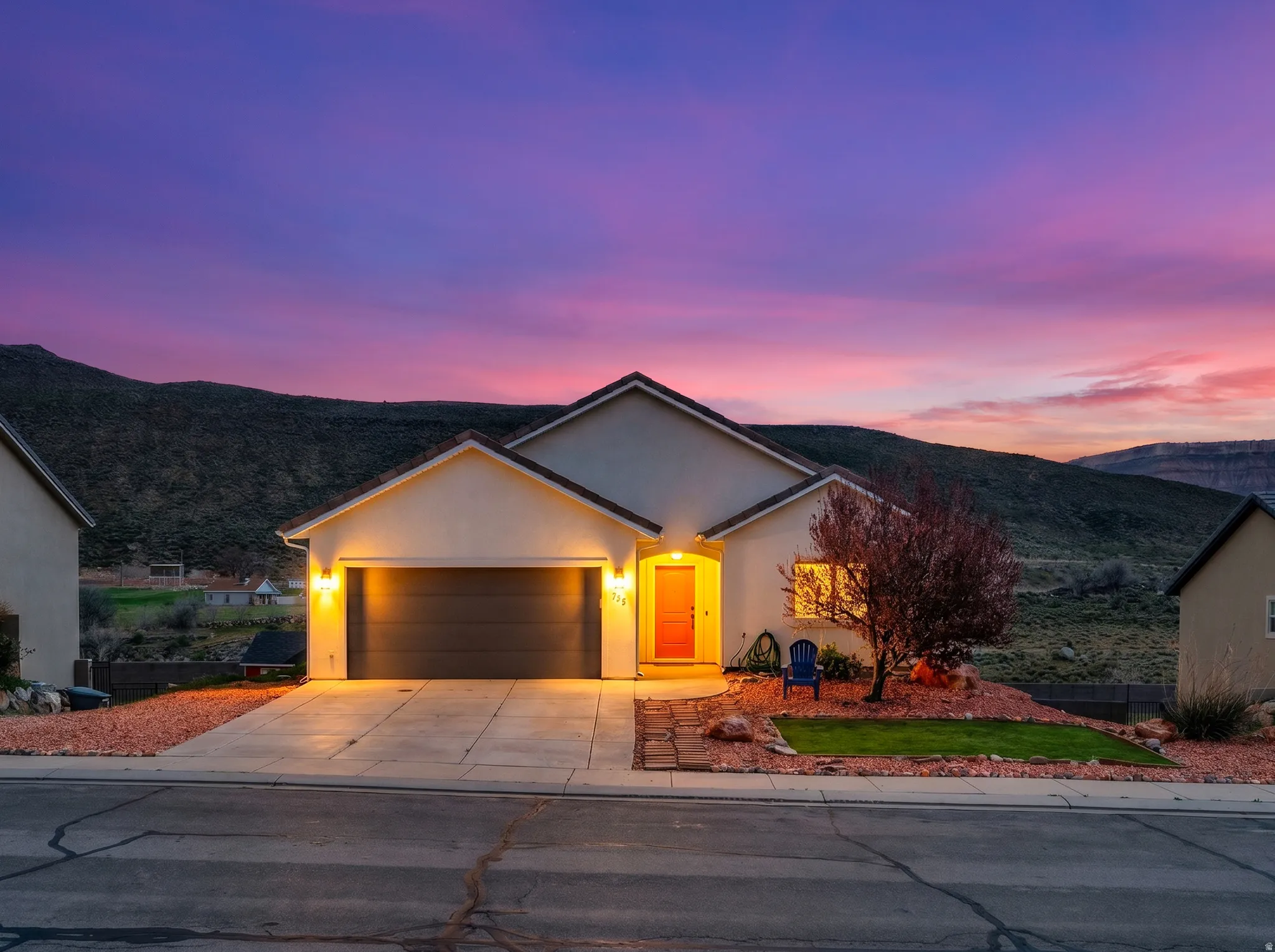 Single-story residence featuring a two-car garage, concrete driveway, and stucco exterior