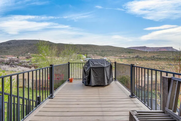 Outdoor deck with composite plank flooring and dark metal railings