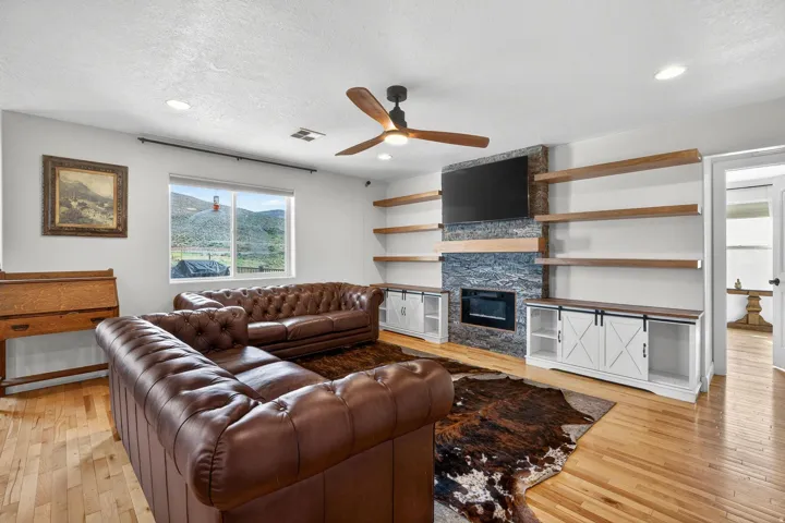 Living area featuring light wood-finish flooring and recessed lighting