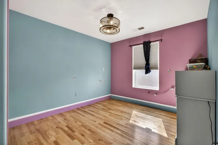 Hardwood flooring complements the bright wall colors